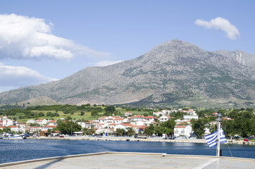 Fototapeta na wymiar View of Samothraki island and port Kamariotissa from ferry in the sea, Greece