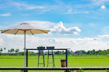 umbrella and coffee table at rice field