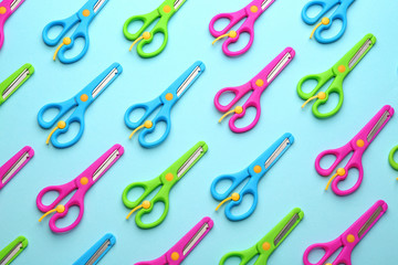 Fototapeta na wymiar Set of training scissors on color background, flat lay