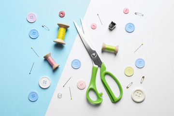 Flat lay composition with scissors on color background