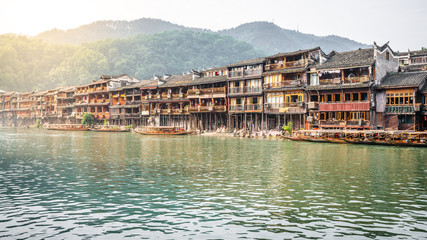 Fototapeta na wymiar Old Chinese houses on riverside in Fenghuang ancient town Hunan China