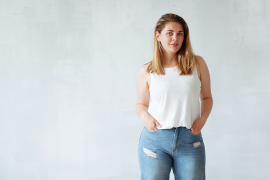 Young beautiful woman in white shirt and jeans