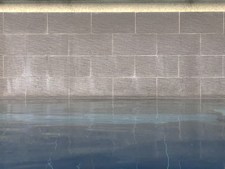 close up of swimming pool with brick wall