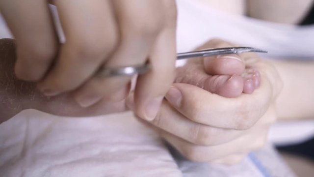 baby feet. mom cuts baby nails.