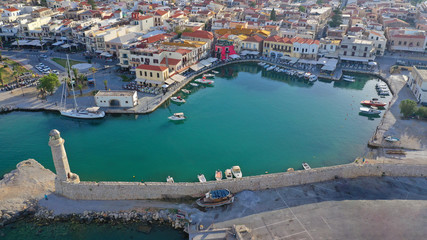 Fototapeta premium Aerial drone photo of unique old picturesque Venetian port with old lighthouse in the heart of famous city of Rethymno, Crete island, Greece
