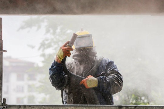 Sand blasting process  Industial worker using sand blasting process preparation cleaning surface on steel before painting