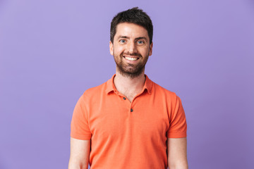 Obraz premium Happy young handsome bearded man posing isolated over violet purple wall background.