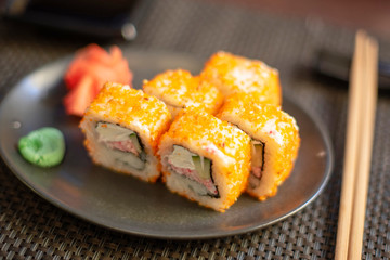 set of California rolls on dark background