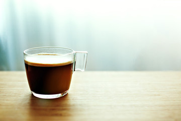 Cup of cappuccino on wooden background in stylish ceramic cup