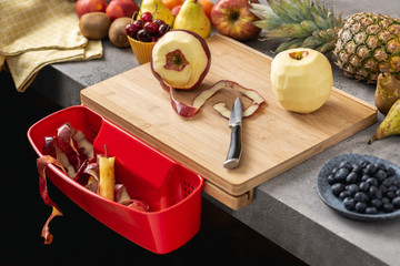 Wood Cutting Board with Waste Container, Santoku Chef Knife and Fresh Fruits. Healthy Eating Concept.
