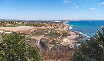 panorama of the mediterranean coast line south of the rosh hanikra grottos showing agricultural shade house plantations and kibbutz kfar rosh hanikra in the background
