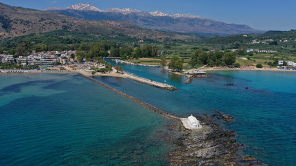 Fototapeta premium Aerial drone photo of famous for wedding ceremonies chapel of Agios Nikolaos built at sea with a small path connecting to mainland, Georgioupoli, Chania, Crete island, Greece