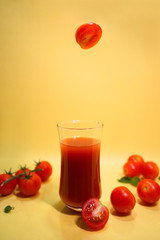  tomato jumping into a glass.