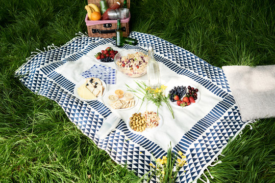 Healthy picnic snacks on a blanket in grass