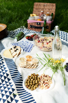 Healthy picnic snacks on a blanket in grass