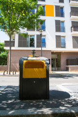 Waste bins in a city centre of Massy in France in front of a building