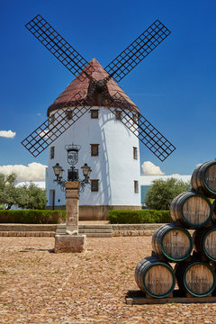 Windmill in Valdepeñas with wine barrels