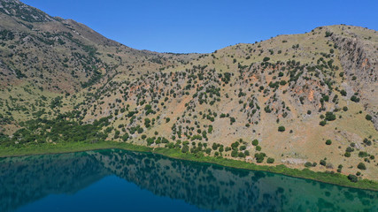 Fototapeta na wymiar Aerial drone panoramic photo of famous natural lake of Kournas with amazing colours and unique nature surrounded by mountains, Chania prefecture, Crete island, Greece