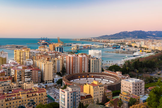 Spain, Malaga, view over the harbor and La Malagueta bullring by sunrise