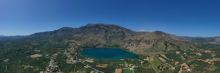 Obraz premium Aerial drone panoramic photo of famous natural lake of Kournas with amazing colours and unique nature surrounded by mountains, Chania prefecture, Crete island, Greece