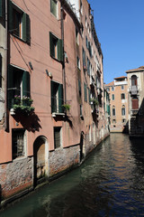 Fototapeta na wymiar Historical houses along a canal in Venice, Italy
