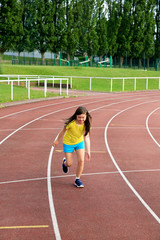 Fototapeta premium Little girl have fun on the stadium
