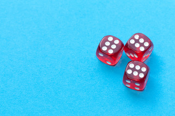 Red dices on blue background.