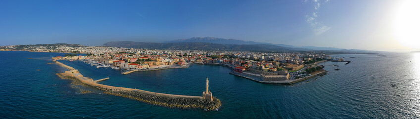 Fototapeta na wymiar Aerial drone photo of iconic Venetian lighthouse in the entrance of picturesque old port of Chania at sunset with beautiful colours, Crete island, Greece