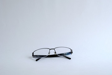 Reading glasses on a white background. Space for text.