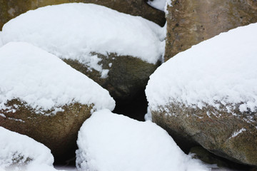 snow over the big round stones background