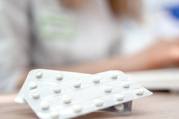 Medicine. Pills and Doctor in white uniform on blurred background. Pharmacy, people and health concept. Drug prescription for treatment medication. copyspase