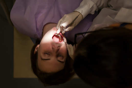 woman dentist attending to a patient