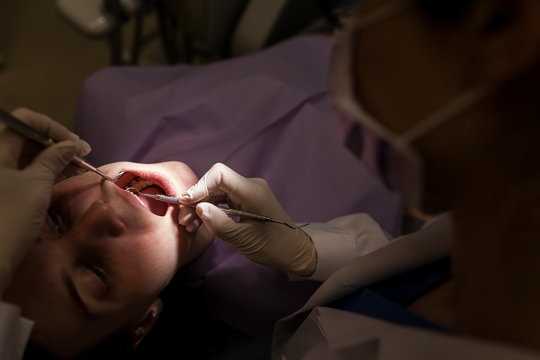 woman dentist attending to a patient