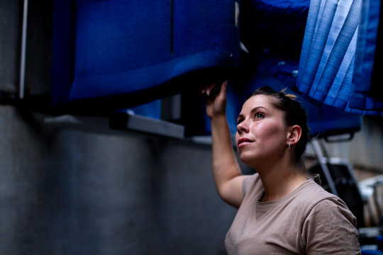 Attractive female soldier looking up while standing inside modern military transport