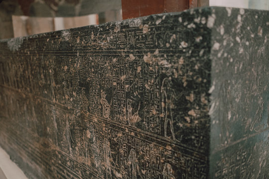 Cairo, Egypt - April, 12 2019: Ancient damaged stone with carved hieroglyphs displayed in museum