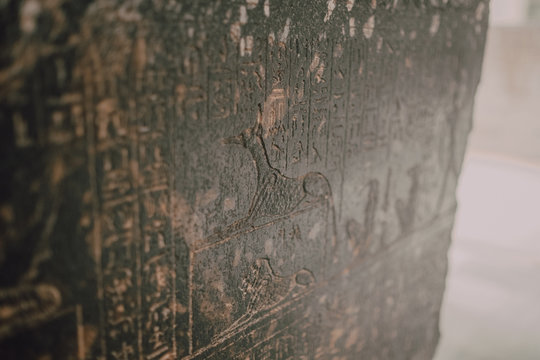 Cairo, Egypt - April, 12 2019: Old wall covered with hieroglyphs in ancient tomb