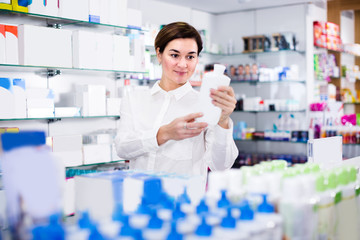 Woman 25-35 years old is browsing rows of body care products