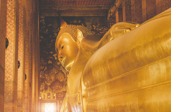 Sleeping golden Buddha statue ancient art.