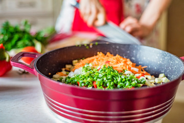 Chopped fresh vegetables in saucepan. Cooking vegetables
