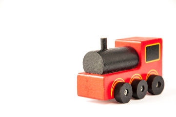 Fototapeta premium Children's toy. Old wooden train. Red with black. On a white background