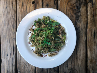 Nutty Fusilli (Italian pasta) with chicken, vegetables, Arugula and pesto sauce.  Gluten free dish. Flat lay.  Top view.