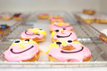Fresh donuts on display racks at the donut shop.