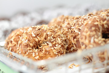 Fresh donuts on display racks at the donut shop.
