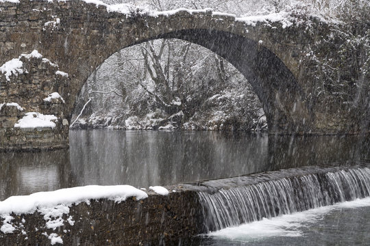Beautiful winter landscape of Puente Romano ancient bridge at Serrilla, Spain