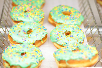Fresh donuts on display racks at the donut shop.