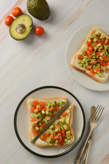 Toast with cream cheese, avocado and cherry tomatoes. Healthy food. Copy space.