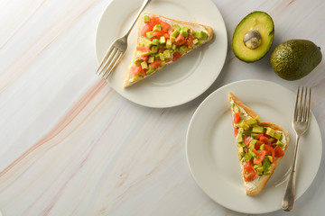 Toast with cream cheese, avocado and cherry tomatoes. Healthy food. Copy space.