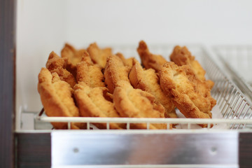Fresh donuts on display racks at the donut shop.