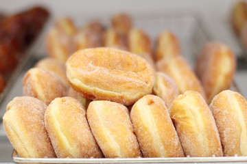 Fresh donuts on display racks at the donut shop.