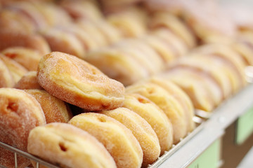 Fresh donuts on display racks at the donut shop.